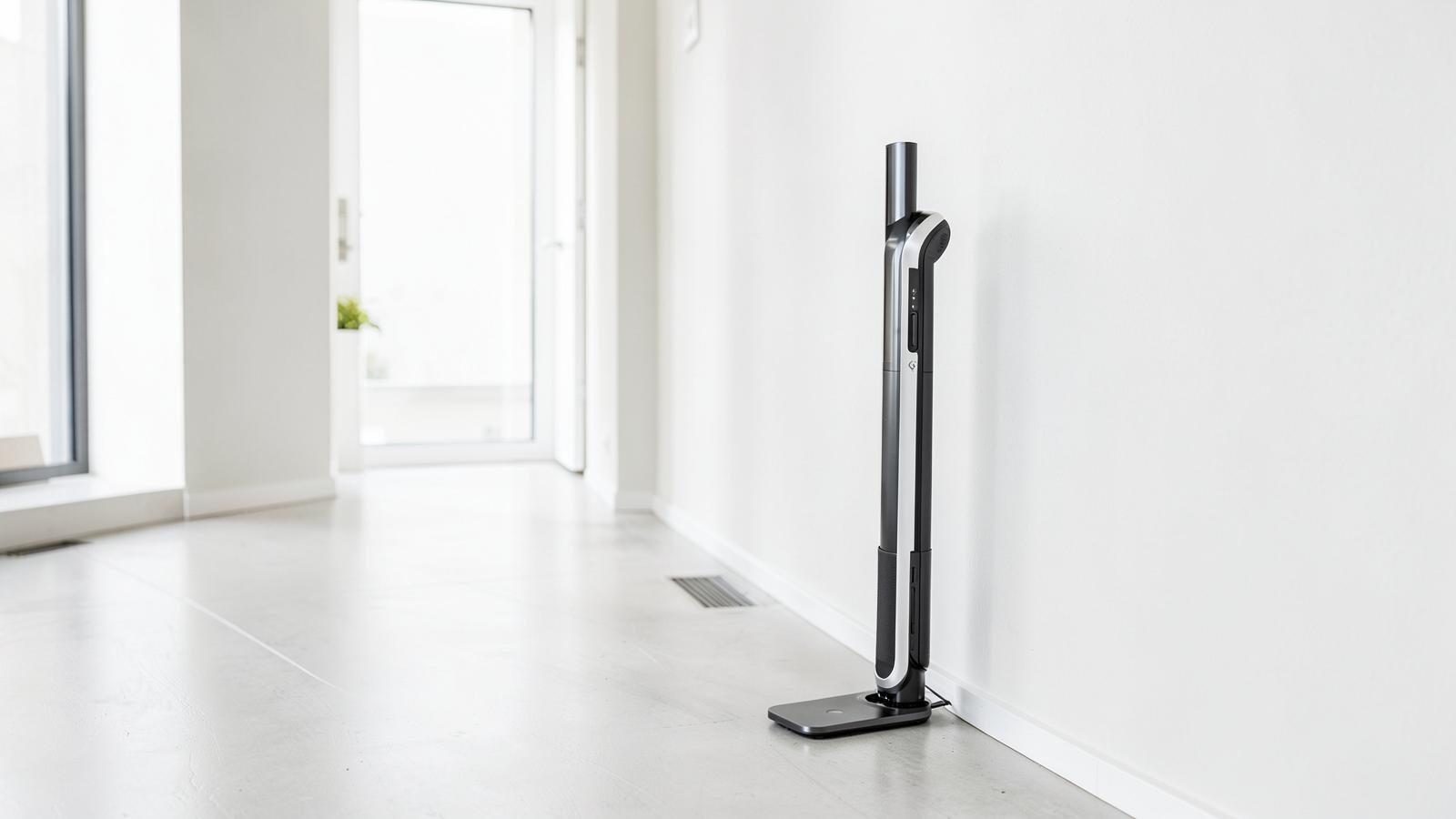 Tall self-emptying docking station beside a wall in a bright hallway